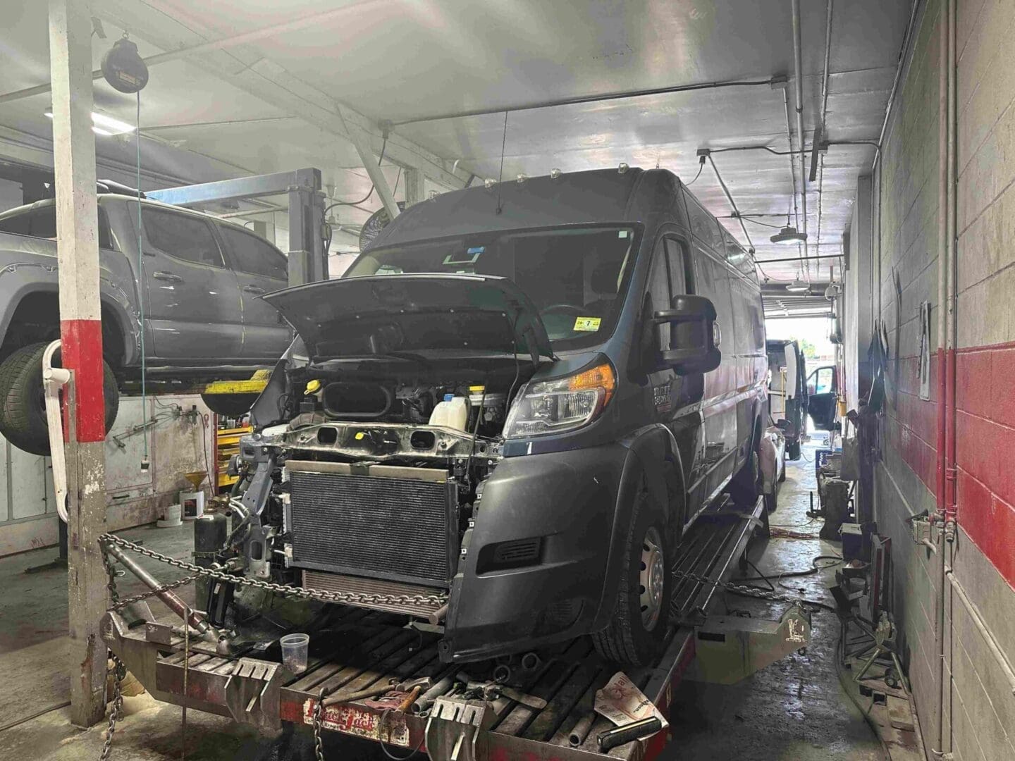 A van is being worked on in the garage.
